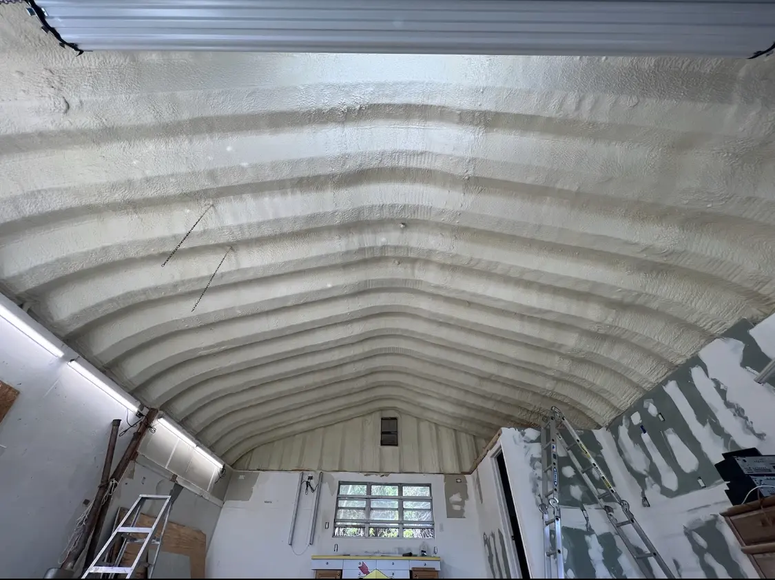 Spray polyurethane foam applied to the underside of a metal roof deck in Bedford